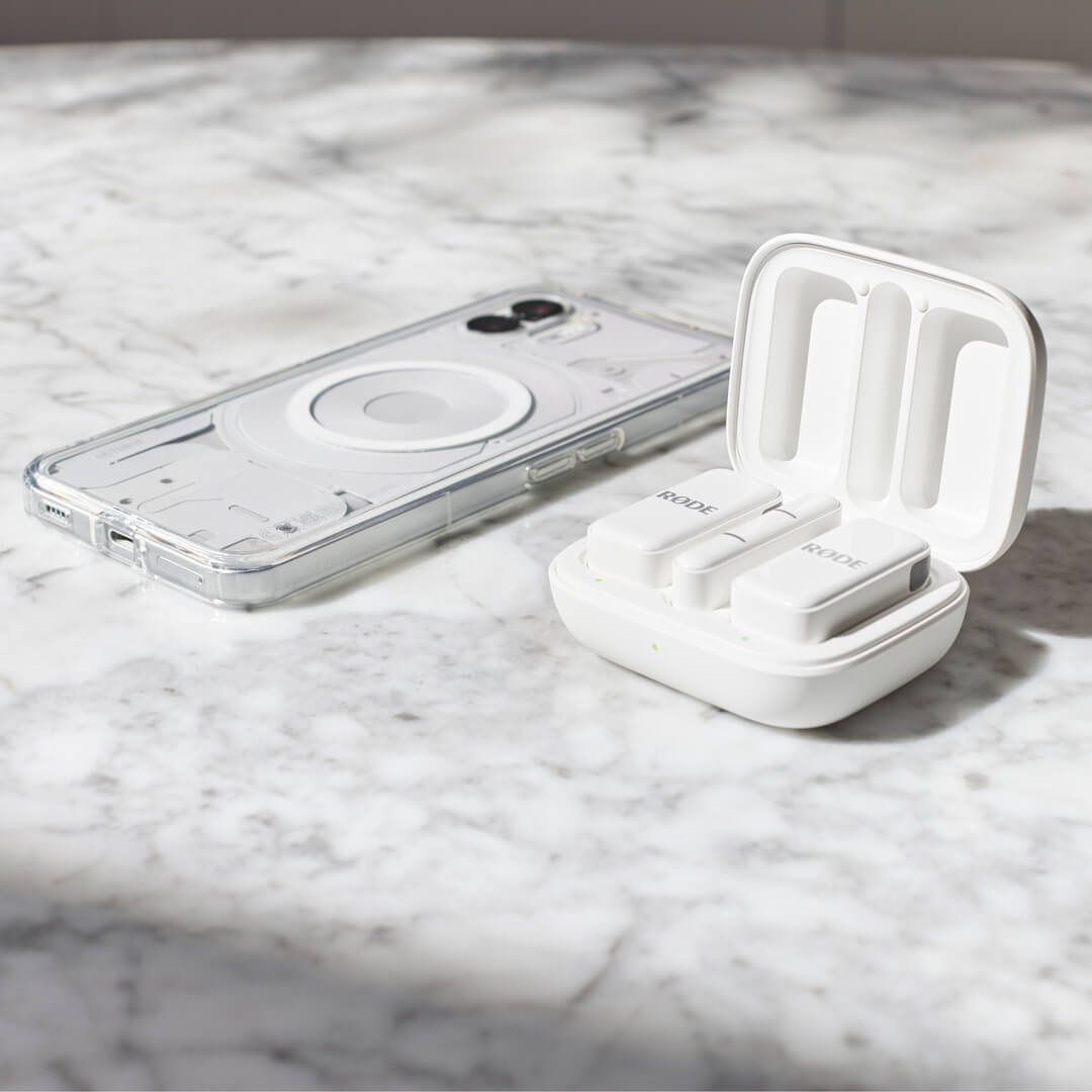 White Wireless Micro and iPhone on marble table